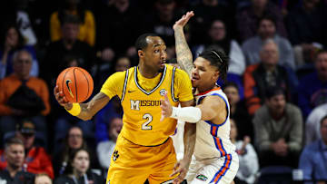 Missouri Tigers guard Tamar Bates (2) looks to facilitate the offense, while defended by guard Will Richard (5)  in a game versus the Florida Gators this season.