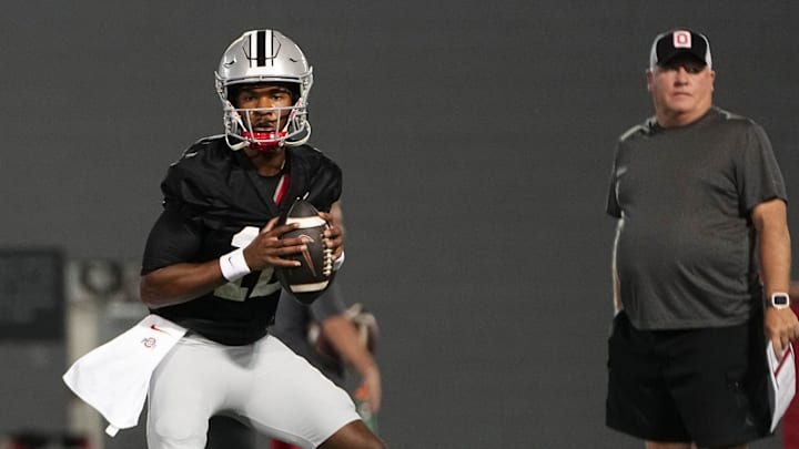 Mar 7, 2024; Columbus, OH, USA; Ohio State Buckeyes quarterback Air Noland (12) takes a snap beside offensive coordinator Chip Kelly during spring football practice at the Woody Hayes Athletic Center.