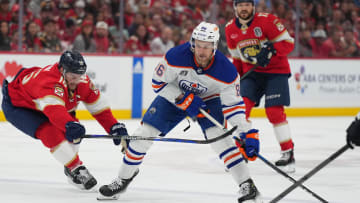 Florida Panthers forward Aleksander Barkov (16) reaches for the puck against Edmonton Oilers defenseman Philip Broberg (86)