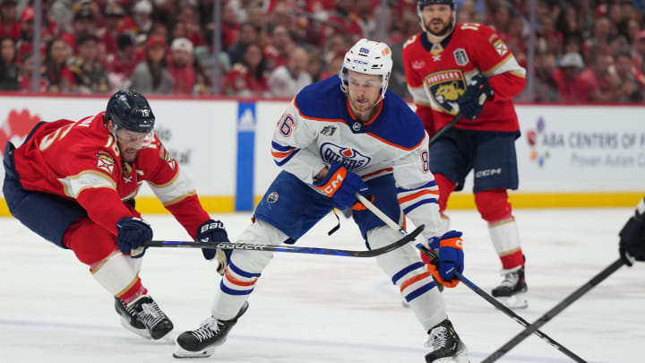 Florida Panthers forward Aleksander Barkov (16) reaches for the puck against Edmonton Oilers defenseman Philip Broberg (86)