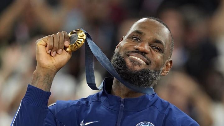 Aug 10, 2024; Paris, France; United States guard LeBron James (6) celebrates with the gold medal after the game against France in the men's basketball gold medal game during the Paris 2024 Olympic Summer Games at Accor Arena. 