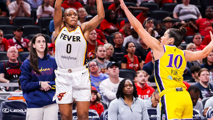 Indiana Fever guard Kelsey Mitchell (0) attempts a 3-pointer against Los Angeles Sparks guard Kelsey Plum (10) on Thursday, June 26, 2025, during a game between the Indiana Fever and the Los Angeles Sparks at Gainbridge Fieldhouse in Indianapolis. The Los Angeles Sparks defeated the Indiana Fever, 85-75. Indiana Fever guard Kelsey Mitchell (0) attempts a 3-pointer against Los Angeles Sparks guard Kelsey Plum (10) on Thursday, June 26, 2025, during a game between the Indiana Fever and the Los Angeles Sparks at Gainbridge Fieldhouse in Indianapolis. The Los Angeles Sparks defeated the Indiana Fever, 85-75.