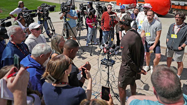 Members of the media crowd around fifth round pick Shedeur Sanders during a press conference before day two of NFL rookie min