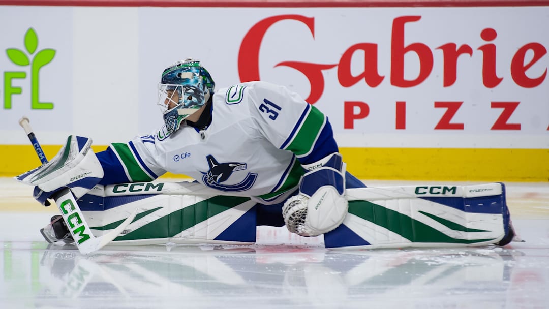 Nov 23, 2024; Ottawa, Ontario, CAN; Vancouver Canucks goalie Arturs Silovs (31) stretches during warmup prior to game against the Ottawa Senators at the Canadian Tire Centre. Mandatory Credit: Marc DesRosiers-Imagn Images