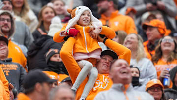 A young fan is raised for the Simba cam during a NCAA football game between Tennessee and Vanderbilt at Neyland Stadium in Knoxville, Tenn., on Nov. 29, 2025.