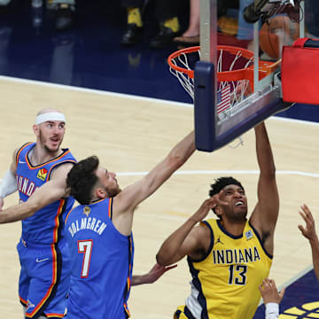 Jun 19, 2025; Indianapolis, Indiana, USA; Indiana Pacers center Tony Bradley (13) shoots the ball against Oklahoma City Thunder guard Alex Caruso (9), forward Chet Holmgren (7) and guard Aaron Wiggins (21) in the second quarter during game six of the 2025 NBA Finals at Gainbridge Fieldhouse.