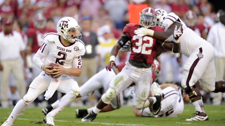 Texas A&M Aggies quarterback Johnny Manziel under pressure from the Alabama Crimson Tide defense Texas A&M Aggies quarterback Johnny Manziel under pressure from the Alabama Crimson Tide defense