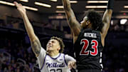 Dec 30, 2024; Manhattan, Kansas, USA; Kansas State Wildcats guard Coleman Hawkins (33) shoots against Cincinnati Bearcats forward Dillon Mitchell (23) during the second half at Bramlage Coliseum. Mandatory Credit: Jay Biggerstaff-Imagn Images