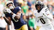 Notre Dame wide receiver Malachi Fields, left, catches a pass and runs the ball for a touchdown 