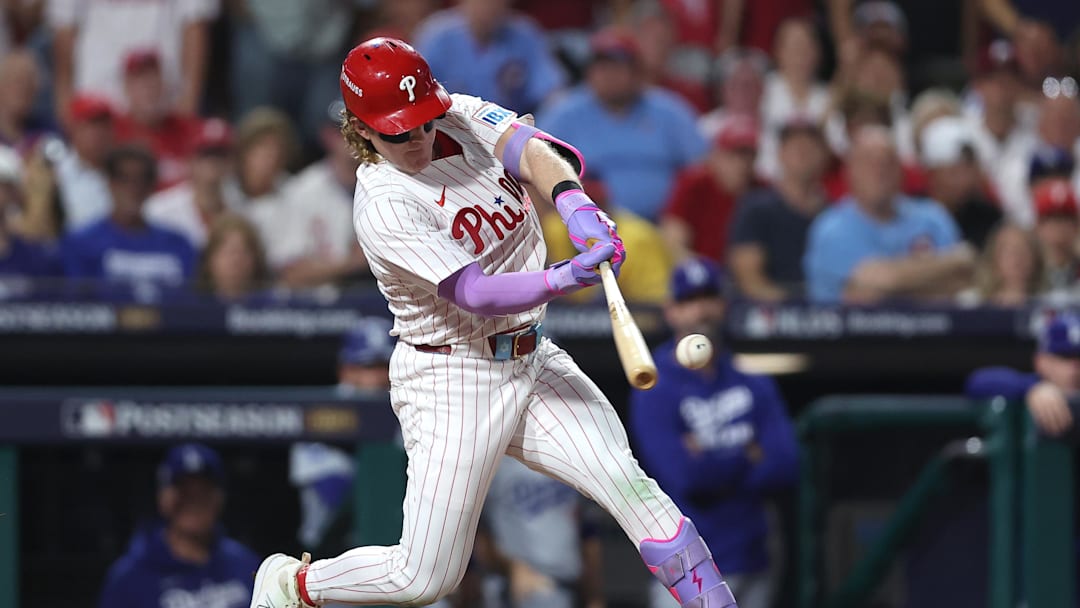 Oct 4, 2025; Philadelphia, Pennsylvania, USA; Philadelphia Phillies left fielder Harrison Bader (2) hits an RBI sacrifice fly against the Los Angeles Dodgers in the second inning during game one of the NLDS round for the 2025 MLB playoffs at Citizens Bank Park. Mandatory Credit: Bill Streicher-Imagn Images