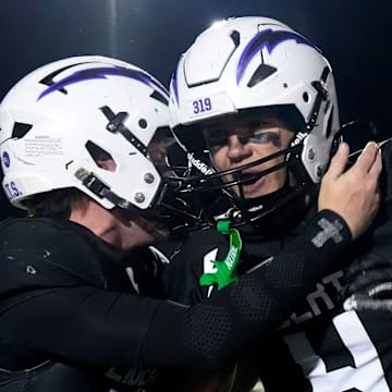 Iowa City Liberty’s Reece Rettig (17) and Iowa City Liberty’s Pryor Reiners (4) celebrate Nov. 7, 2025 after defeating Southeast Polk in an Iowa high school quarterfinal football game in North Liberty, Iowa.