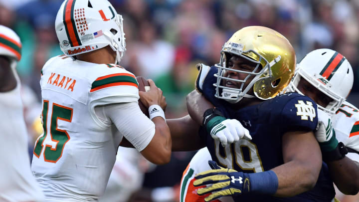 Oct 29, 2016; South Bend, IN, USA; Miami Hurricanes quarterback Brad Kaaya (15) is pressured by Notre Dame Fighting Irish defensive lineman Jerry Tillery (99) in the third quarter at Notre Dame Stadium. Notre Dame won 30-27. 