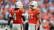 Sep 13, 2025; Miami Gardens, Florida, USA; Miami Hurricanes quarterback Carson Beck (11) celebrates with running back Mark Fletcher Jr. (4) after throwing a touchdown pass against the South Florida Bulls during the first quarter at Hard Rock Stadium. Mandatory Credit: Sam Navarro-Imagn Images
