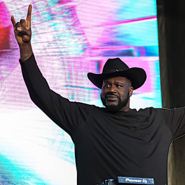 Shaquille O'Neal holds up the sign of the horns during a DJ performance ahead of the College Football Playoff semifinal game between the Texas Longhorns and Ohio State in the Cotton Bowl at AT&T Stadium on Friday, Jan. 10, 2024 in Arlington, Texas.