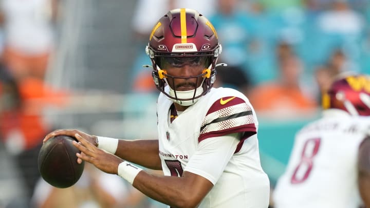 Aug 17, 2024; Miami Gardens, Florida, USA;  Washington Commanders quarterback Jayden Daniels (5) drops back to pass against the Miami Dolphins during the first quarter at Hard Rock Stadium. Mandatory Credit: Jim Rassol-USA TODAY Sports