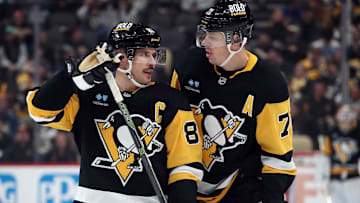 Nov 27, 2024; Pittsburgh, Pennsylvania, USA;  Pittsburgh Penguins center Sidney Crosby (87) and center Evgeni Malkin (71) talk before a face-off against the Vancouver Canucks during the third period at PPG Paints Arena. Mandatory Credit: Charles LeClaire-Imagn Images