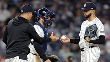Apr 25, 2025; Bronx, New York, USA; New York Yankees manager Aaron Boone (17) takes the ball from relief pitcher Devin Williams (38) during a pitching change during the ninth inning against the Toronto Blue Jays at Yankee Stadium. Mandatory Credit: Brad Penner-Imagn Images