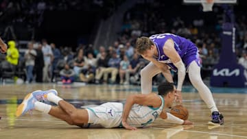 Mar 31, 2025; Charlotte, North Carolina, USA; Charlotte Hornets guard Josh Green (10) loses the ball to Utah Jazz forward Kyle Filipowski (22) during the second half at Spectrum Center. Mandatory Credit: Jim Dedmon-Imagn Images