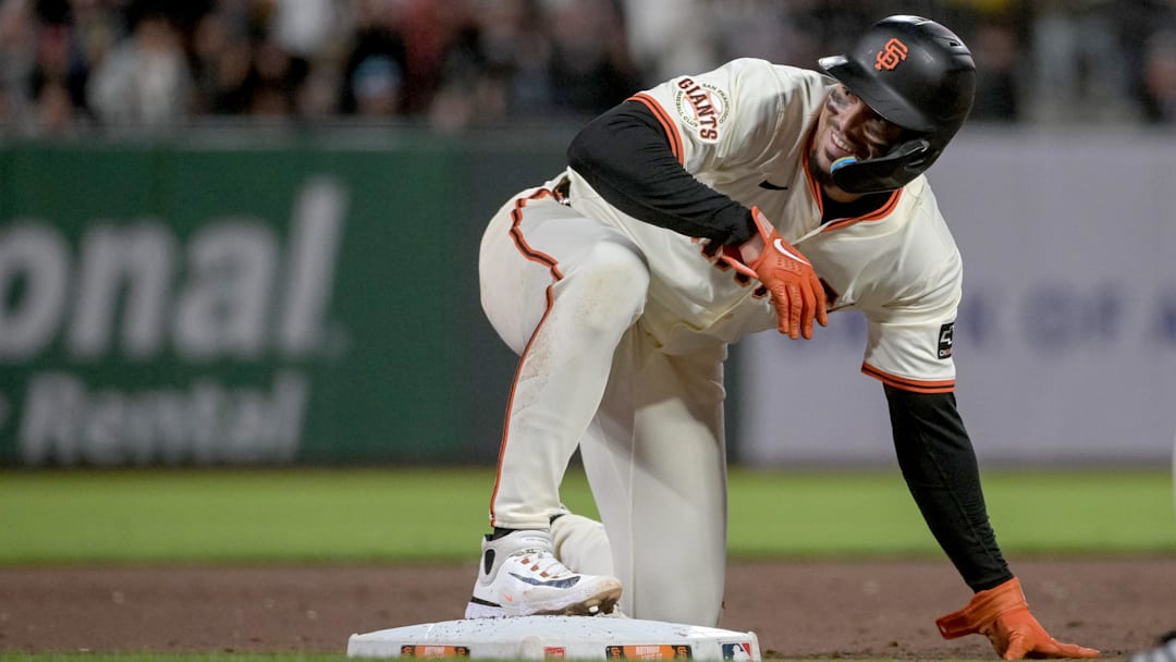 Jul 7, 2025; San Francisco, California, USA; San Francisco Giants shortstop Willy Adames (2) looks to his bench after sliding into third base during the eighth inning of the game against the Philadelphia Phillies at Oracle Park. Mandatory Credit: Ed Szczepanski-Imagn Images