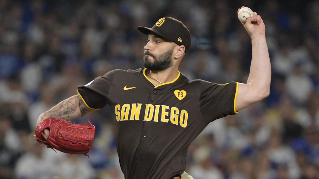 Oct 6, 2024; Los Angeles, California, USA; San Diego Padres pitcher Tanner Scott (66) pitches against the Los Angeles Dodgers in the eighth inning during game two of the NLDS for the 2024 MLB Playoffs at Dodger Stadium. Mandatory Credit: Jayne Kamin-Oncea-Imagn Images