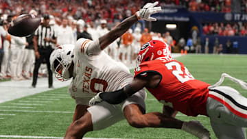 Dec 7, 2024; Atlanta, GA, USA; Texas Longhorns wide receiver DeAndre Moore Jr. (0) attempts to make a catch over Georgia Bulldogs defensive back Malaki Starks (24).