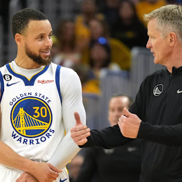 Apr 23, 2023; San Francisco, California, USA; Golden State Warriors guard Stephen Curry (30) talks with head coach Steve Kerr during the third quarter of game four of the 2023 NBA playoffs against the Sacramento Kings at Chase Center. Mandatory Credit: Darren Yamashita-Imagn Images