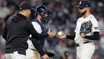 Apr 25, 2025; Bronx, New York, USA; New York Yankees manager Aaron Boone (17) takes the ball from relief pitcher Devin Williams (38) during a pitching change during the ninth inning against the Toronto Blue Jays at Yankee Stadium. Mandatory Credit: Brad Penner-Imagn Images