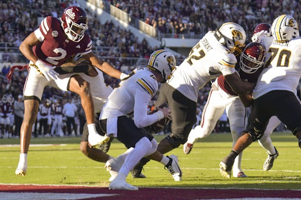 Mississippi State Bulldogs safety Isaac Smith (2) sacks Missouri Tigers quarterback Brady Cook (12) during the first quarter.