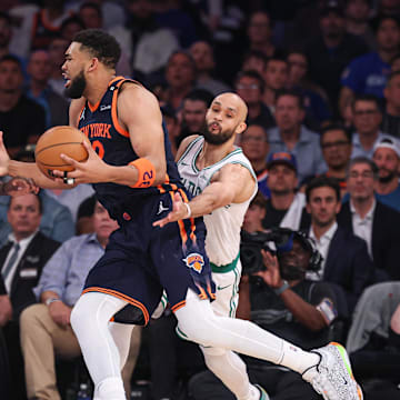May 12, 2025; New York, New York, USA; New York Knicks center Karl-Anthony Towns (32) goes to the basket against Boston Celtics guard Jrue Holiday (4) and guard Derrick White (9) in the second half during game four of the second round for the 2025 NBA Playoffs at Madison Square Garden. Mandatory Credit: Vincent Carchietta-Imagn Images