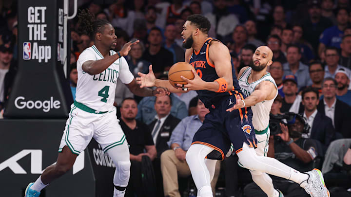 New York Knicks center Karl-Anthony Towns drives against Boston Celtics guard Jrue Holiday during the 2025 NBA Playoffs