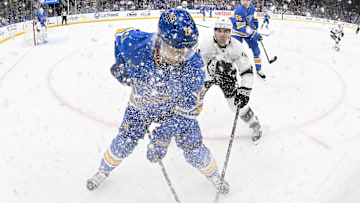 Oct 21, 2025; St. Louis, Missouri, USA; St. Louis Blues defenseman Cam Fowler (17) battle Los Angeles Kings right wing Alex Laferriere (14) for the puck during the first period at Enterprise Center. Mandatory Credit: Jeff Curry-Imagn Images