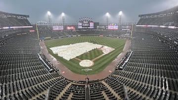 Mar 30, 2025; Chicago, Illinois, USA; A tarp covers the field during a rain delay in the seventh inning of a game between the Chicago White Sox and the Los Angeles Angels at Guaranteed Rate Field. Mandatory Credit: David Banks-Imagn Images
