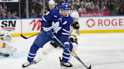 Jan 4, 2025; Toronto, Ontario, CAN; Toronto Maple Leafs forward John Tavares (91) battles with Boston Bruins forward Pavel Zacha (18) to get control of the puck during the first period at Scotiabank Arena. Mandatory Credit: John E. Sokolowski-Imagn Images