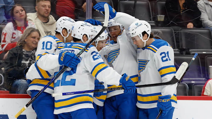 Oct 25, 2025; Detroit, Michigan, USA;  St. Louis Blues right wing Jordan Kyrou (25) receives congratulations from teammates after scoring in the first period against the Detroit Red Wings at Little Caesars Arena. Mandatory Credit: Rick Osentoski-Imagn Images