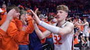 Feb 2, 2025; Champaign, Illinois, USA; Illinois Fighting Illini guard Kasparas Jakucionis (32) gets a hand from fans after an 87-79 win over the Ohio State Buckeyes at State Farm Center. Mandatory Credit: Ron Johnson-Imagn Images