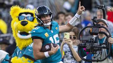 Nov 16, 2025; Jacksonville, Florida, USA; Jacksonville Jaguars quarterback Trevor Lawrence (16) celebrates after rushing for a touchdown against the Los Angeles Chargers during the third quarter at EverBank Stadium. 