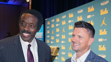 Dec 9, 2025; Los Angeles, CA, USA; UCLA Bruins football coach Bob Chesney (right) with CBS Los Angeles sports director Jim Hill at introductory press conference at Renee Luskin Conference Center Centennial Ballroom. Mandatory Credit: Kirby Lee-Imagn Images