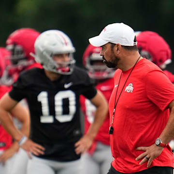 Ohio State Buckeyes head coach Ryan Day watches players warm up during the first football practice of the season at the Woody Hayes Athletic Center on July 31, 2025.