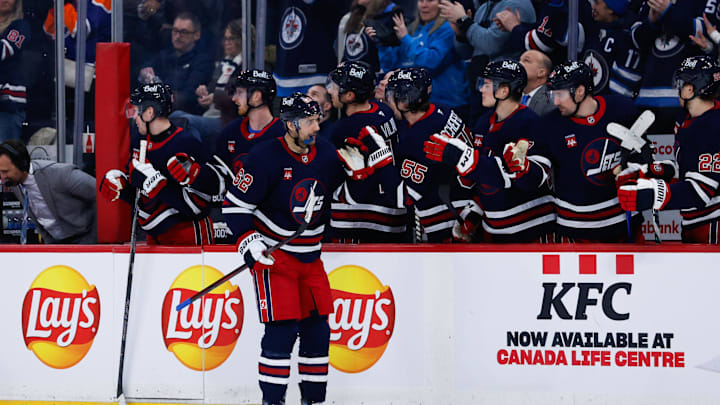 Feb 4, 2025; Winnipeg, Manitoba, CAN;  Winnipeg Jets forward Nino Niederreiter (62) is congratulated by his team mates on his goal against the Carolina Hurricanes during the first period at Canada Life Centre. Mandatory Credit: Terrence Lee-Imagn Images