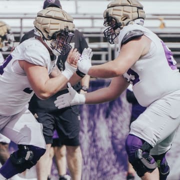 Walk-ons Parker Cross (54) and Roice Cleeland (63) tangle during a spring practice drill. 