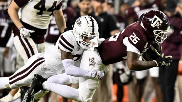 Mississippi State Bulldogs safety Chris Keys (27) tackles Texas A&M Aggies running back David Bailey (26) .