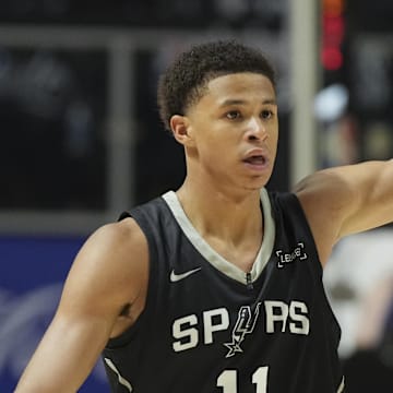 Jul 10, 2025; Las Vegas, NV, USA; San Antonio Spurs forward Carter Bryant (11) reacts to a teammates basket against the Philadelphia 76ers in the fourth quarter of their game at Thomas & Mack Center. Mandatory Credit: Candice Ward-Imagn Images