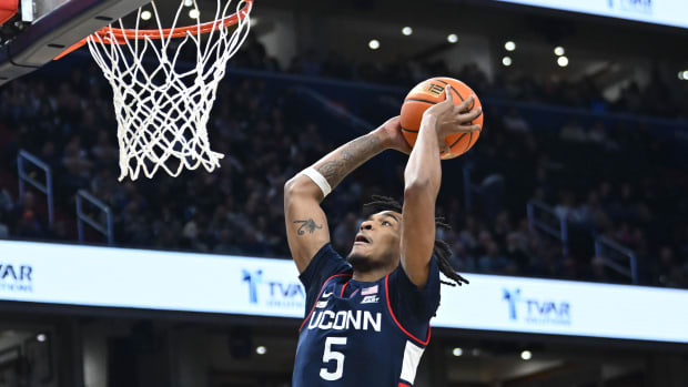 Feb 10, 2024; Washington, District of Columbia, USA; Connecticut Huskies guard Stephon Castle (5) dunks the ball against the Georgetown Hoyas during the first half at Capital One Arena. Mandatory Credit: Brad Mills-USA TODAY Sports