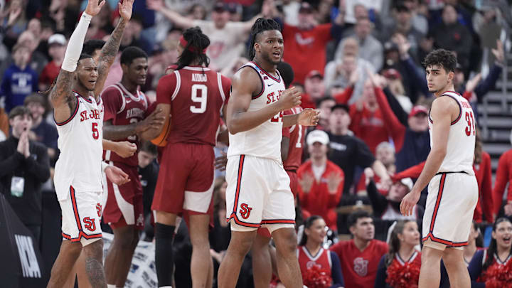 Mar 22, 2025; Providence, RI, USA; St. John's basketball guard Deivon Smith (5), forward Zuby Ejiofor (24) and guard Lefteris Liotopoulos (31) react to a play during the second half of a second round men’s NCAA Tournament game against the Arkansas Razorbacks at Amica Mutual Pavilion.