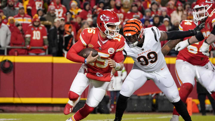 Dec 31, 2023; Kansas City, Missouri, USA; Kansas City Chiefs quarterback Patrick Mahomes (15) scrambles as Cincinnati Bengals defensive end Myles Murphy (99) pressures during the second half at GEHA Field at Arrowhead Stadium. Mandatory Credit: Denny Medley-USA TODAY Sports