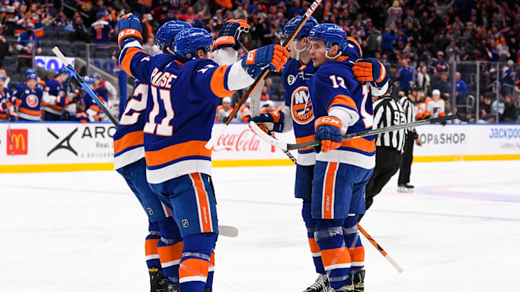 Jan 25, 2022; Elmont, New York, USA; New York Islanders celebrate the goal by center Mathew Barzal