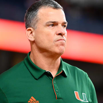 Nov 30, 2024; Syracuse, New York, USA; Miami Hurricanes head coach Mario Cristobal looks on prior to the game against the Syracuse Orange at the JMA Wireless Dome. 