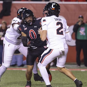 Nov 1, 2025; Salt Lake City, Utah, USA; Cincinnati Bearcats quarterback Brendan Sorsby (2) is pressured by Utah Utes defensive end Logan Fano (0) during the second half at Rice-Eccles Stadium. Mandatory Credit: Rob Gray-Imagn Images