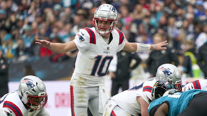 Oct 20, 2024; London, United Kingdom; New England Patriots quarterback Drake Maye (10) signs to players in the first half during an NFL International Series game at Wembley Stadium. Mandatory Credit: Peter van den Berg-Imagn Images