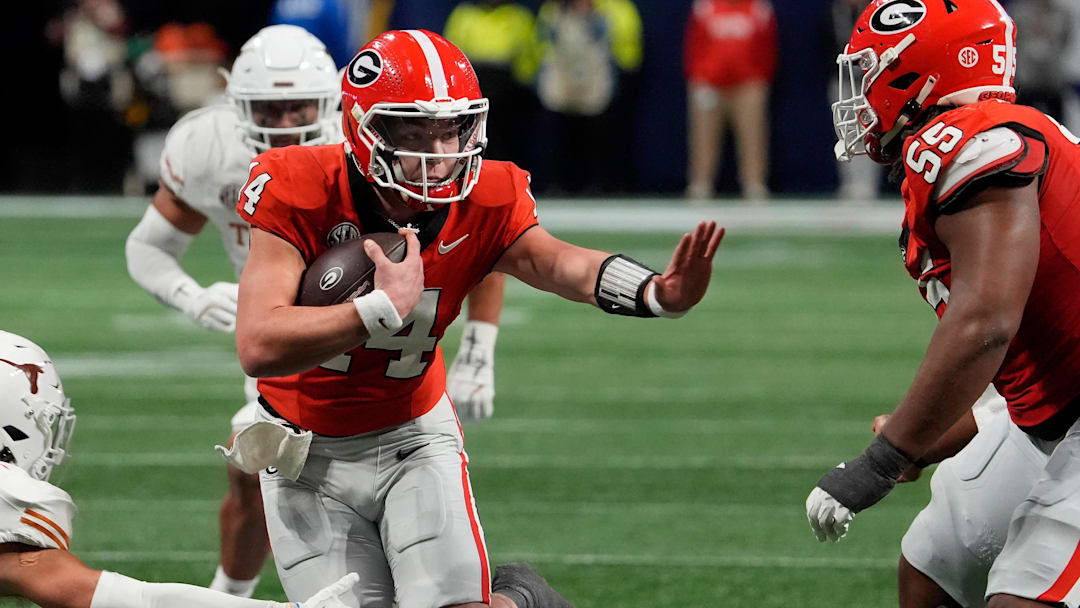 Georgia quarterback Gunner Stockton (14) runs the ball during the second half of the SEC championship game against Texas in Atlanta, on Saturday, Dec. 7, 2024. Georgia quarterback Gunner Stockton (14) runs the ball during the second half of the SEC championship game against Texas in Atlanta, on Saturday, Dec. 7, 2024.